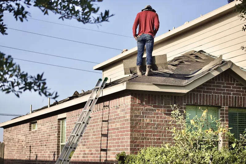 Professional roofer working on a residential roof in Pantown